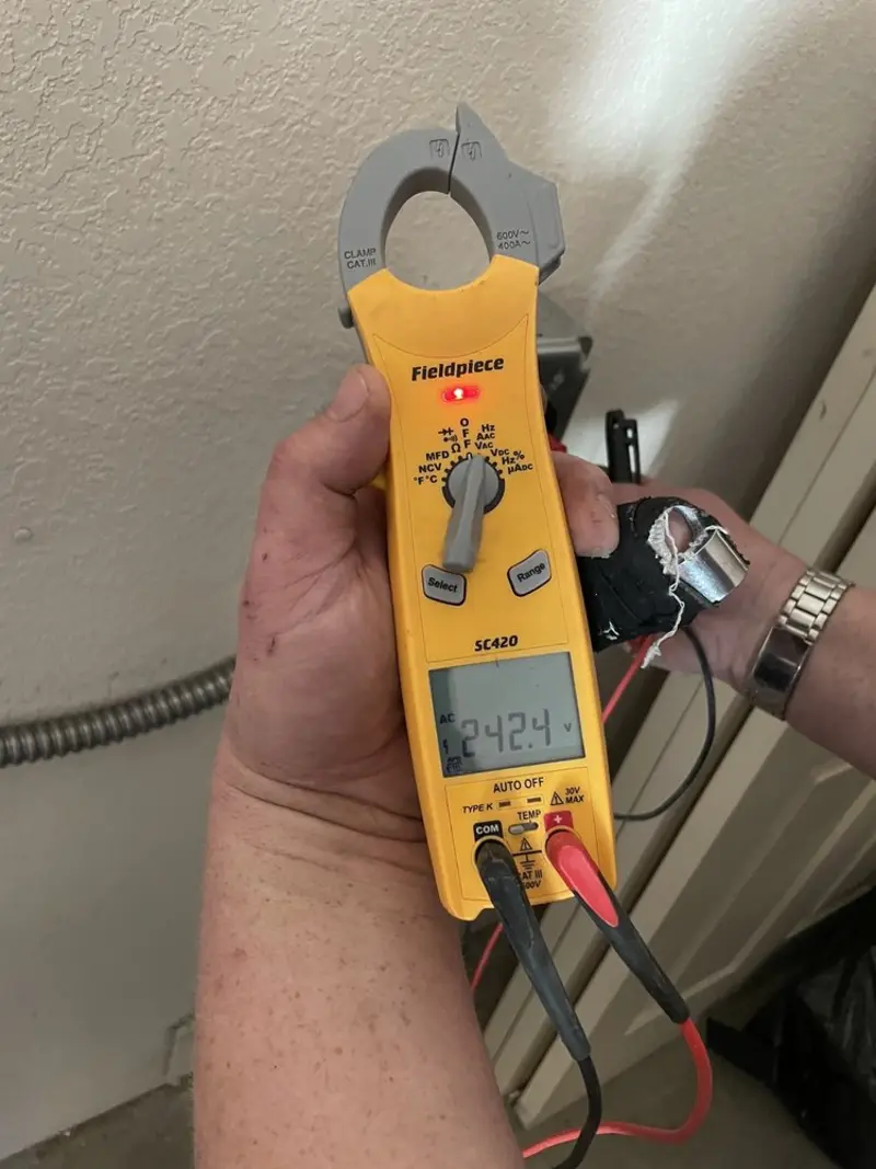 Voltage testing with clamp meter during Recessed Lighting Installation in Oakleaf Plantation